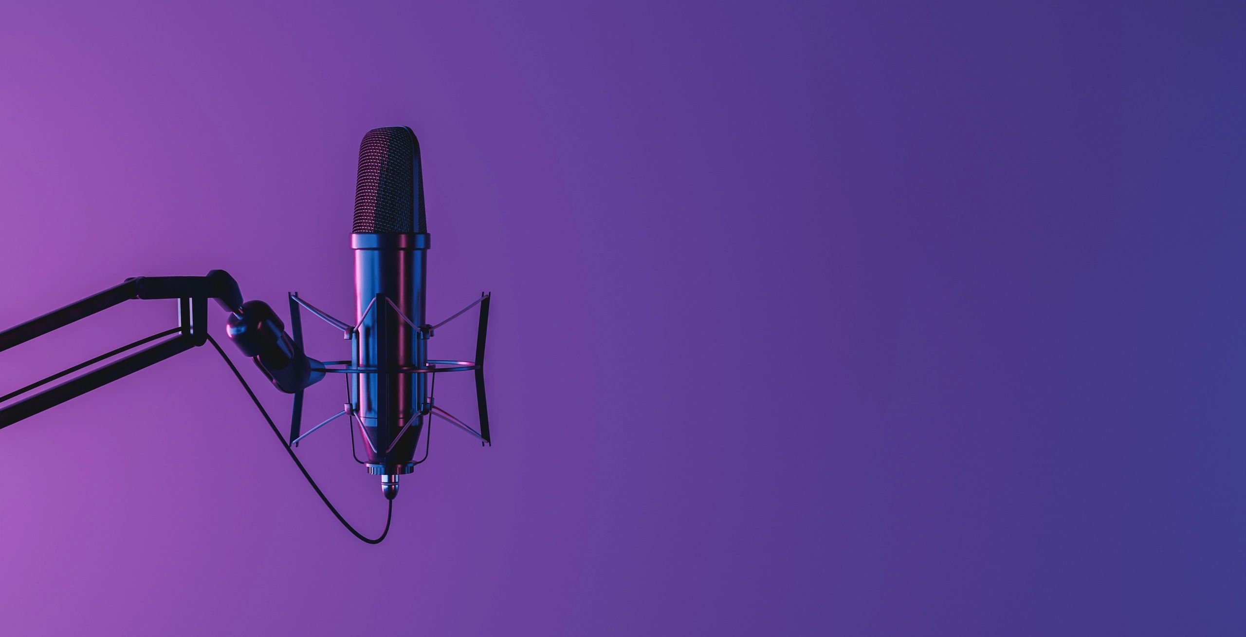 Neon-lit studio microphone on a dark background