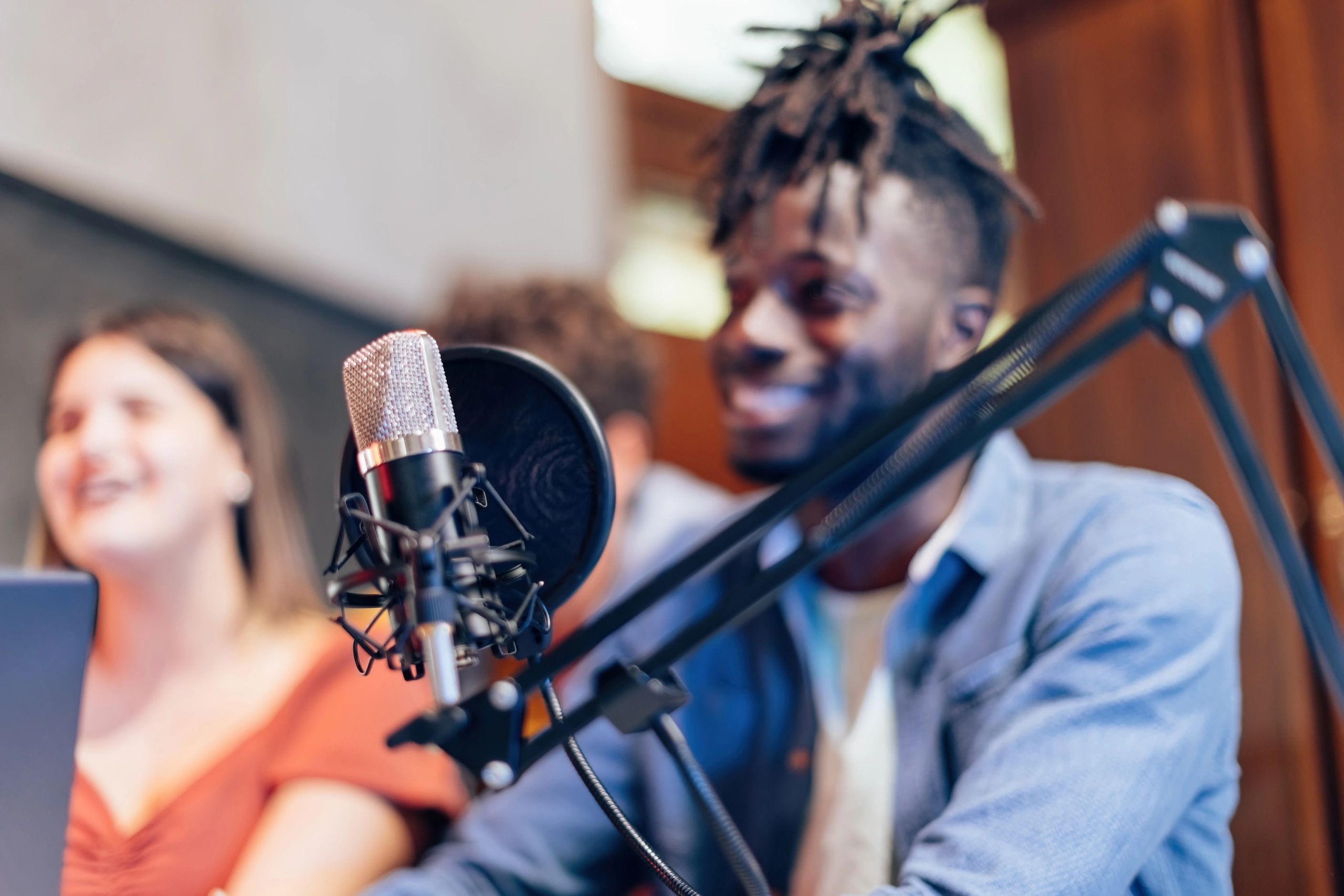 Microphone in foreground with people blurred in the background