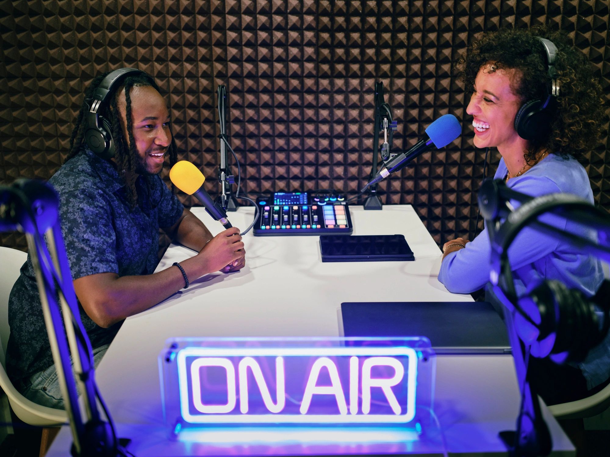 Podcasters recording in a studio