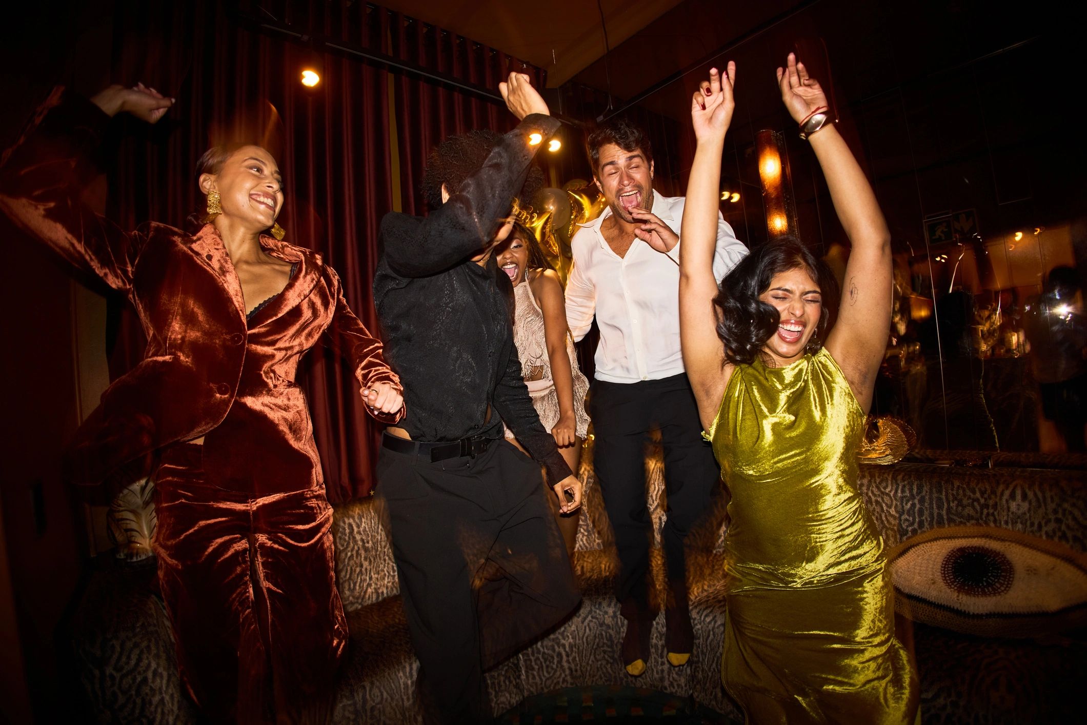 Group of friends cheering on a dance floor