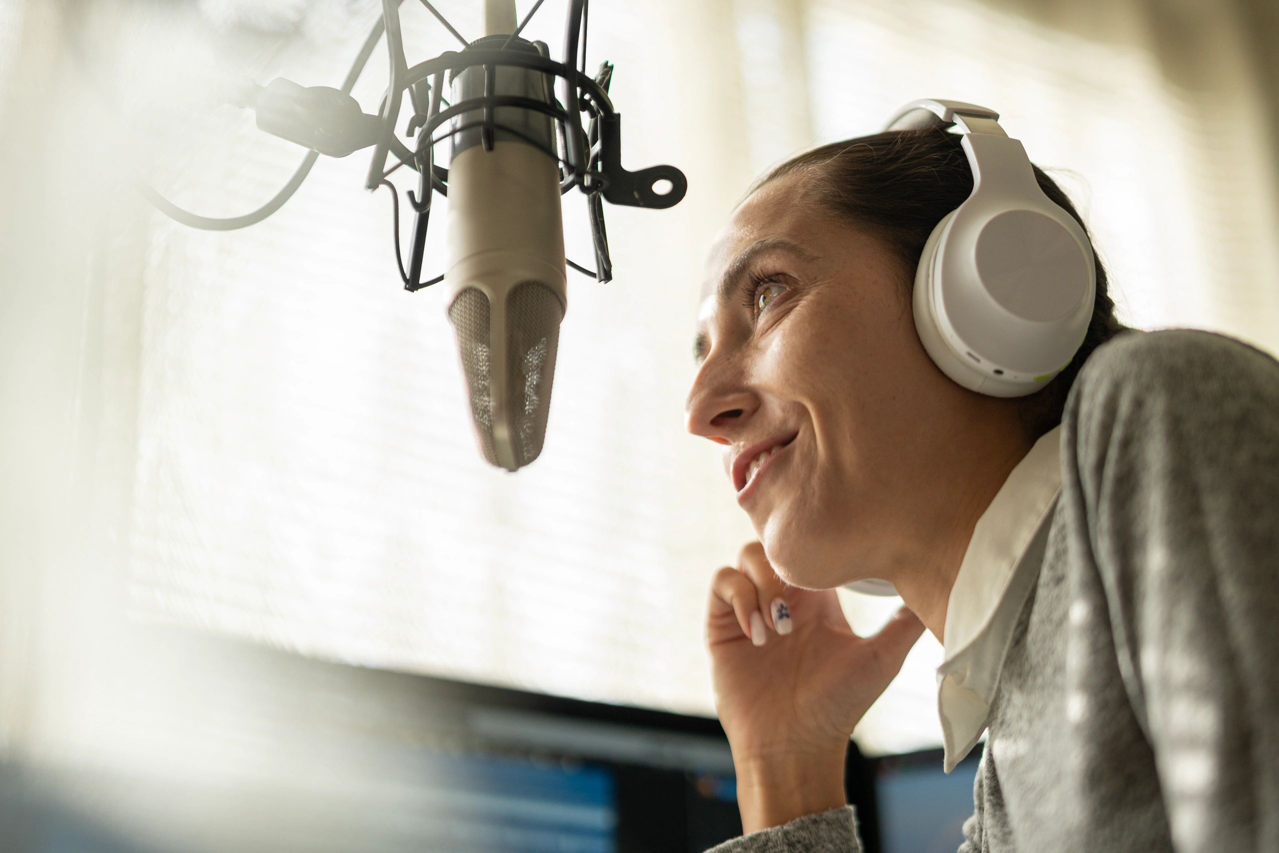 Radio host speaking into a microphone in a studio